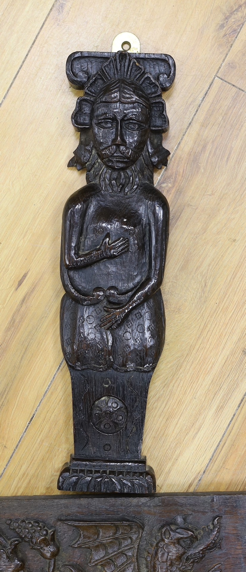 A 17th carved oak figural corbel, a pair of carved oak corbels and a carved oak frieze 14x19cm